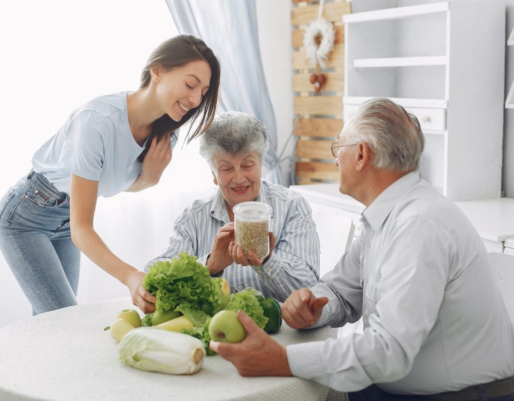 Family in a kitchen. Grandparents with granddaughter. Family made a salad